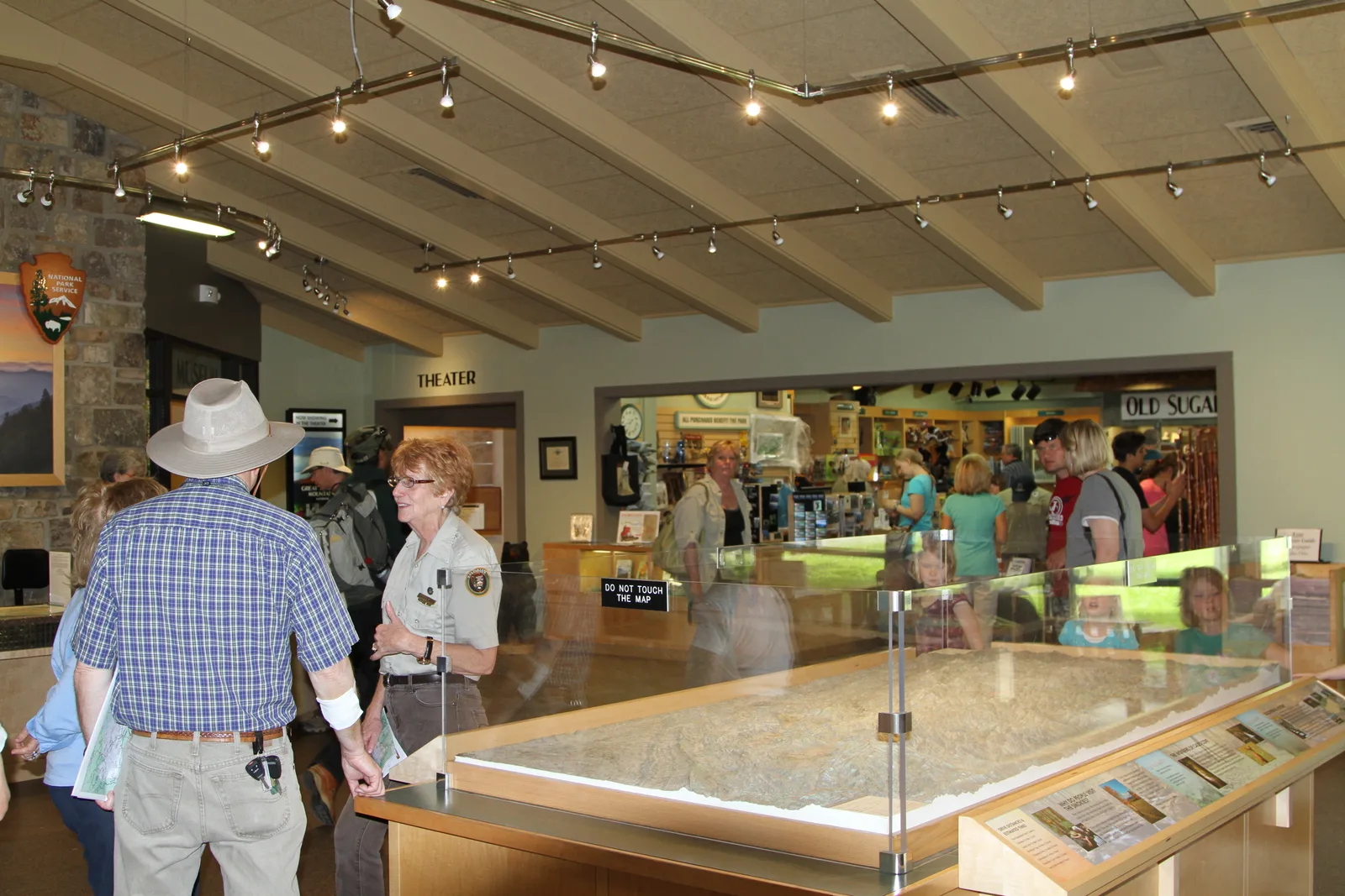 Ranger and visitors beside the relief map inside Sugarlands Visitor Center