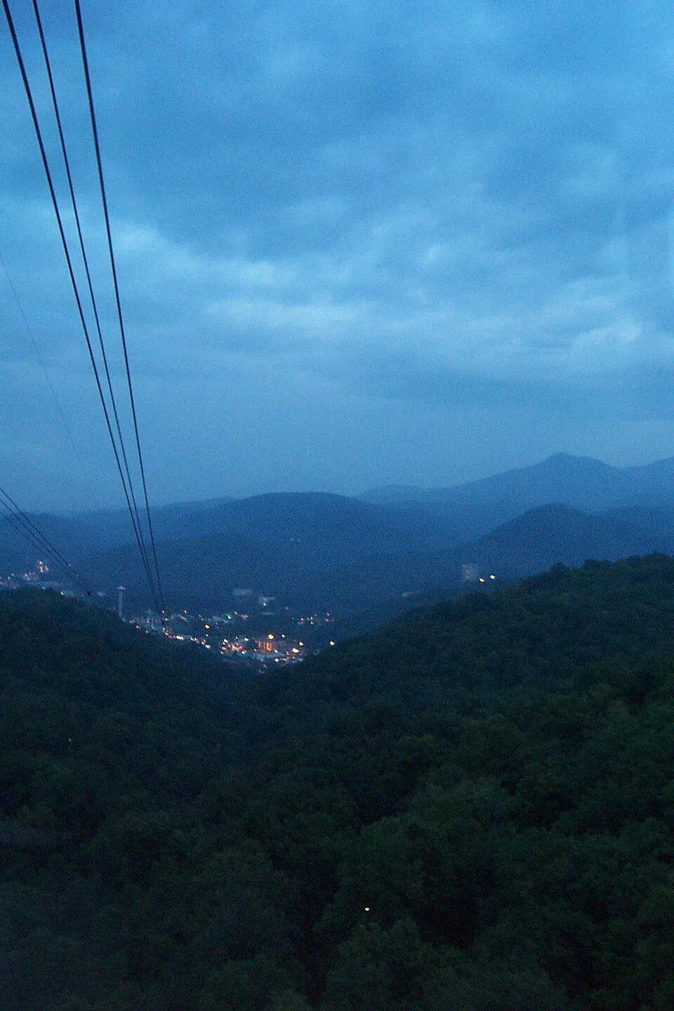 Blue evening mountain ridges and lights of Gatlinburg viewed from the Ober aerial tram
