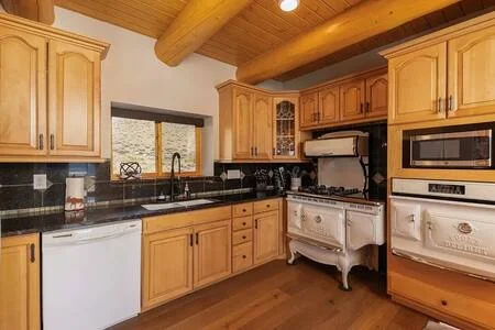 Rustic kitchen with wooden cabinets and gas range