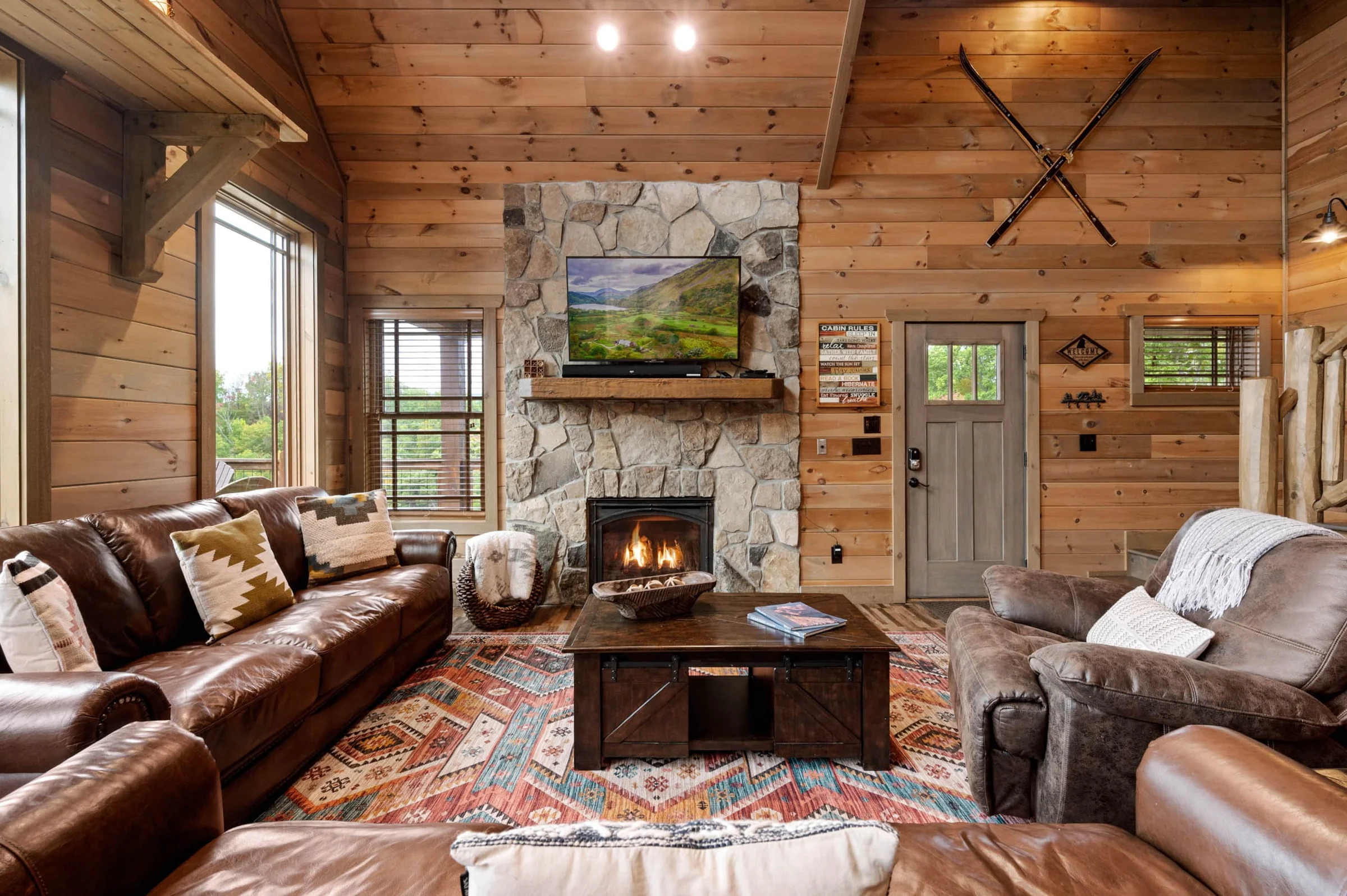 Cozy living room with stone fireplace and leather seating