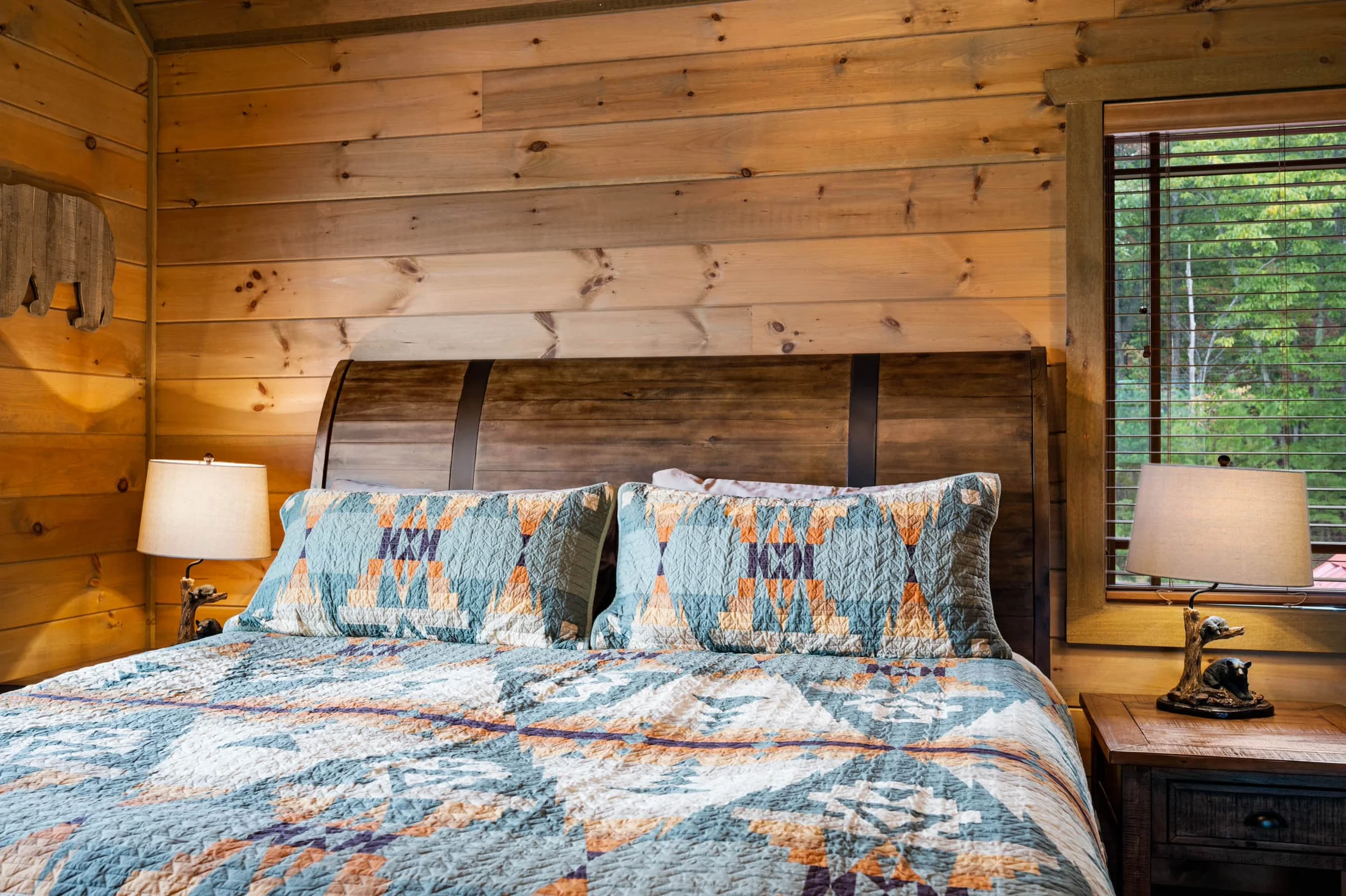 Close-up of rustic headboard and bedside lamps