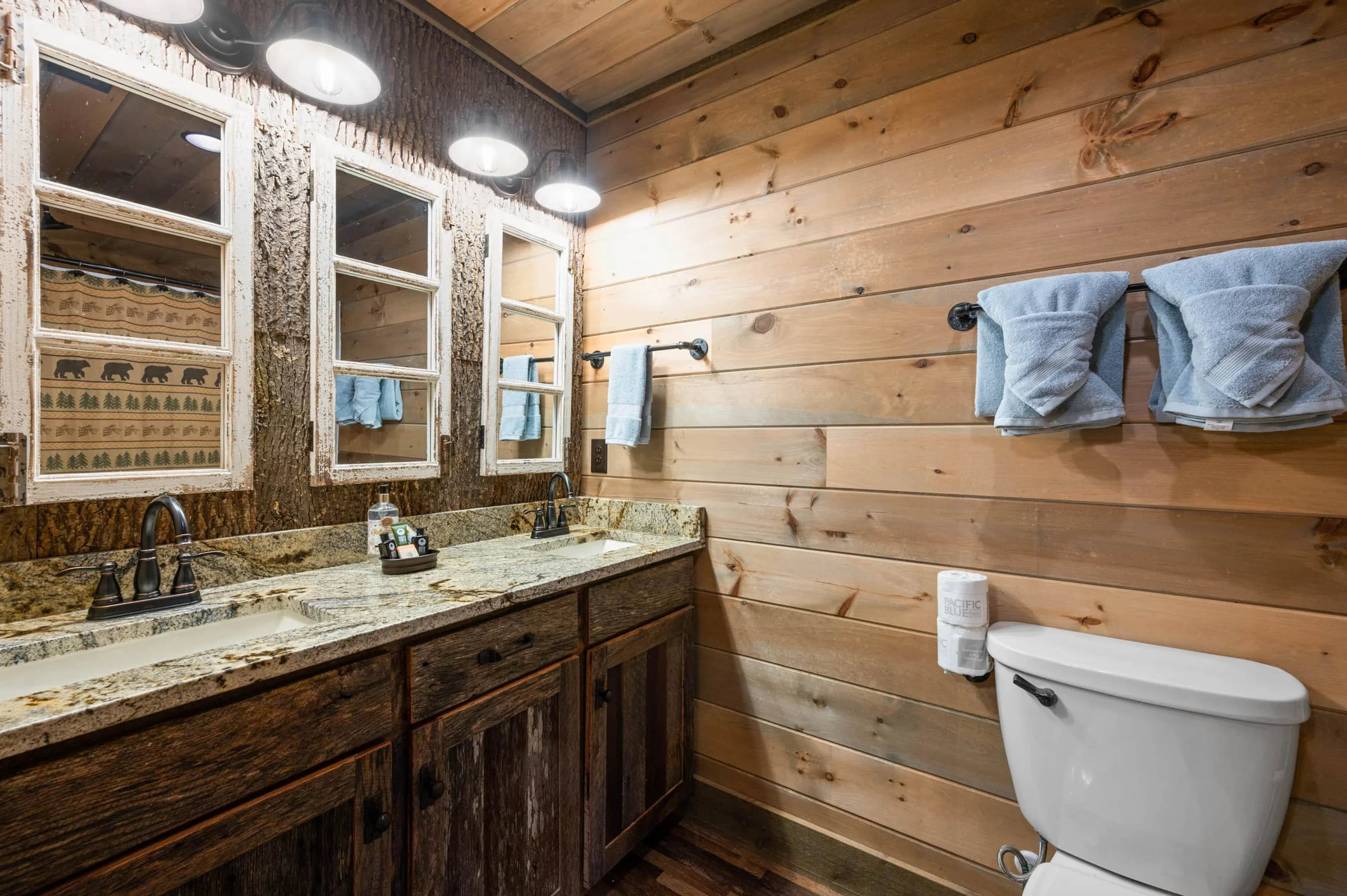 Rustic bathroom vanity with dual sinks and toilet